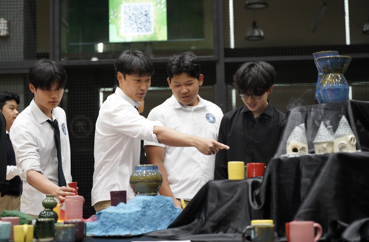 Immersed in vibrant, intricate ceramic designs, students stand in awe. They share observations and reflections on the craftsmanship behind each piece. 